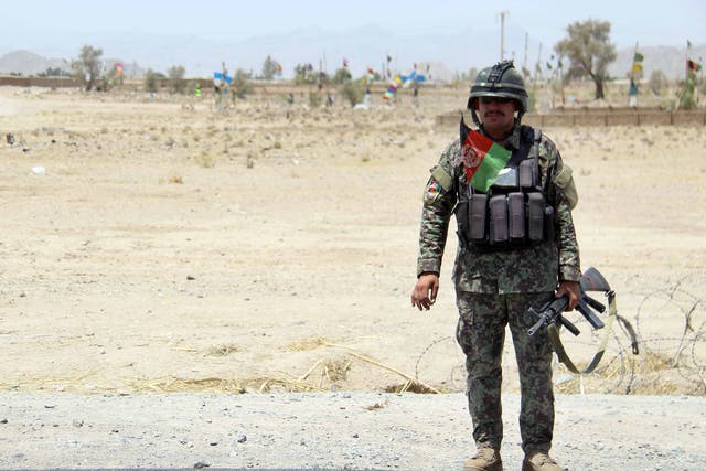 An Afghan Army soldier stands guard at a check point on a highway leading to the Maiwind district of restive Kandahar, Afghanistan, 19 October 2017
