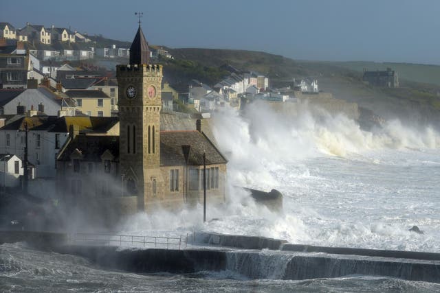 Waves break around the church in the harbour at Porthleven, Cornwall, as Hurricane Ophelia hit the UK and Ireland