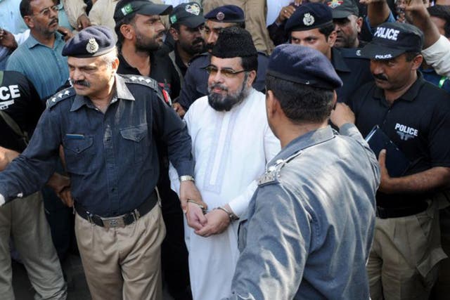 Policemen arrest Mufti Abdul Qavi, a religious cleric, who was accused of inciting the murder of Qandeel Baloch