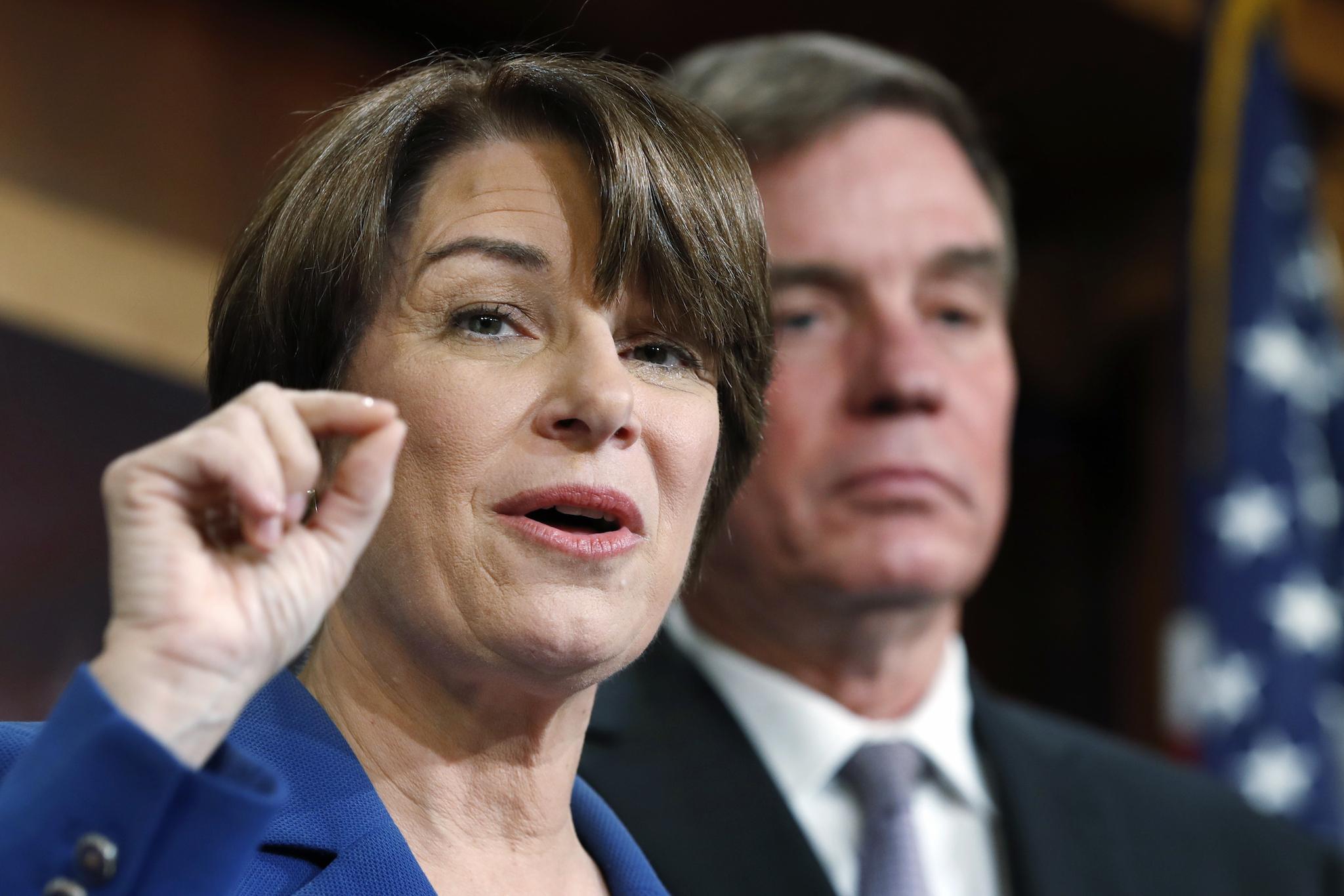 Senator Amy Klobuchar, D-Minn., left, and Senator Mark Warner, D-Va., speak about online political ads and preventing foreign interference in U.S. elections, during a news conference