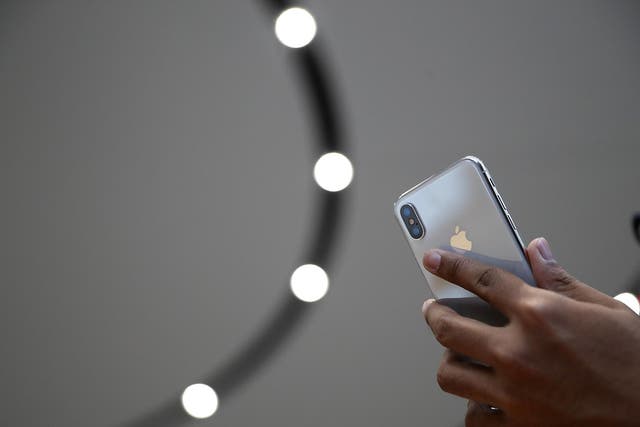 An attendee looks at a new iPhone X during an Apple special event at the Steve Jobs Theatre on the Apple Park campus on September 12, 2017 in Cupertino, California