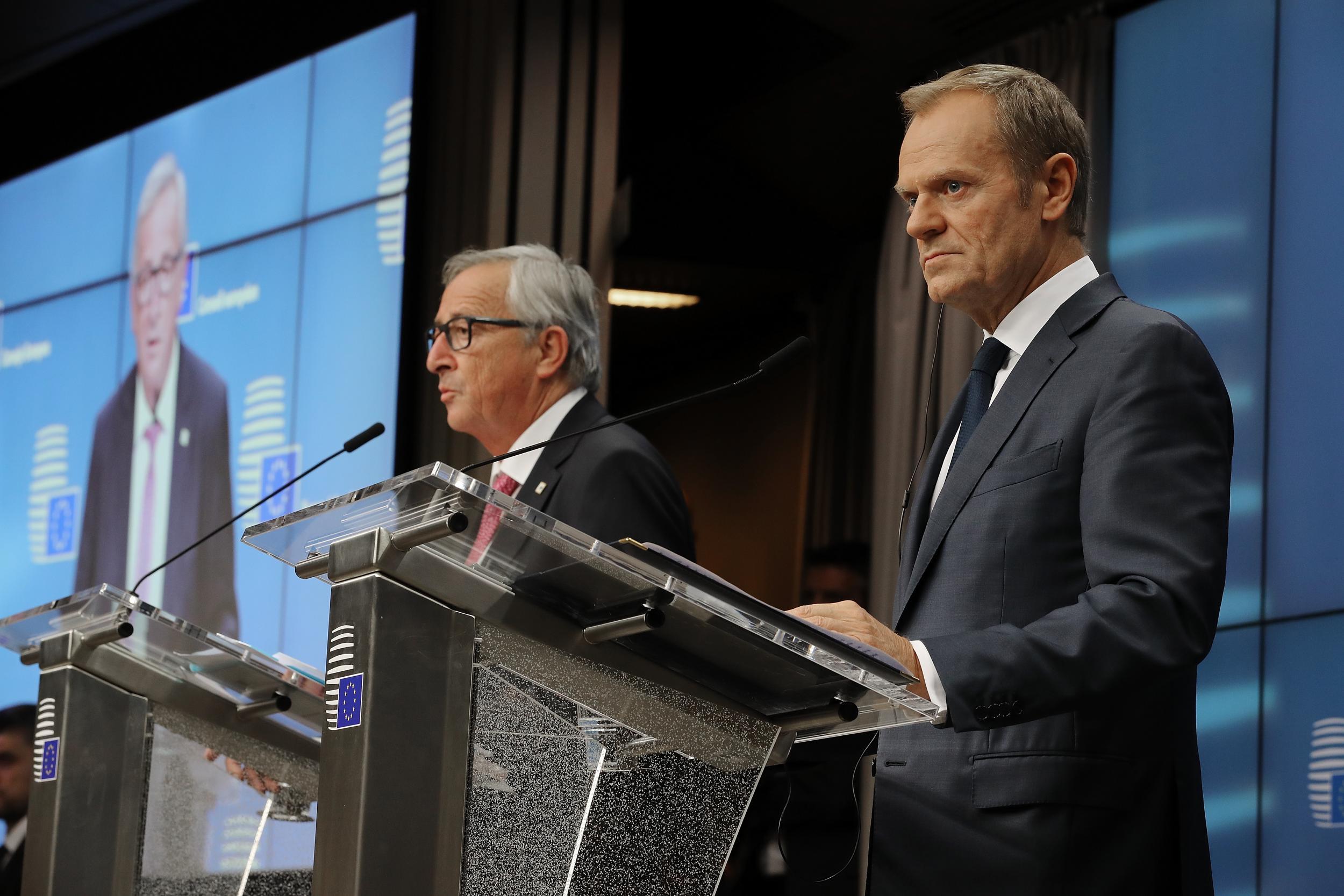 Donald Tusk and Jean-Claude Juncker speak during a press conference