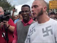 Man wearing shirt covered in swastikas gets punched in head