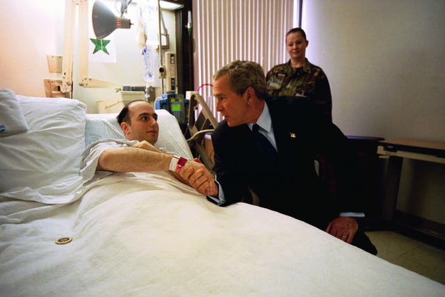 President George W. Bush shakes hands with U.S. Army Specialist Salvatore Cavallaro while visiting Walter Reed Army Medical Center