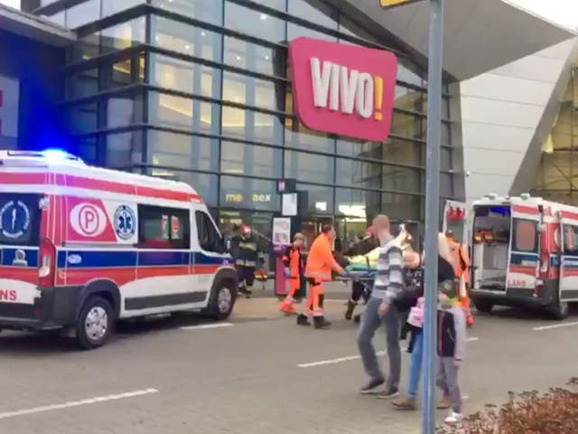 Emergency services transport a victim to an ambulance following the attack in Stalowa Wola, Poland