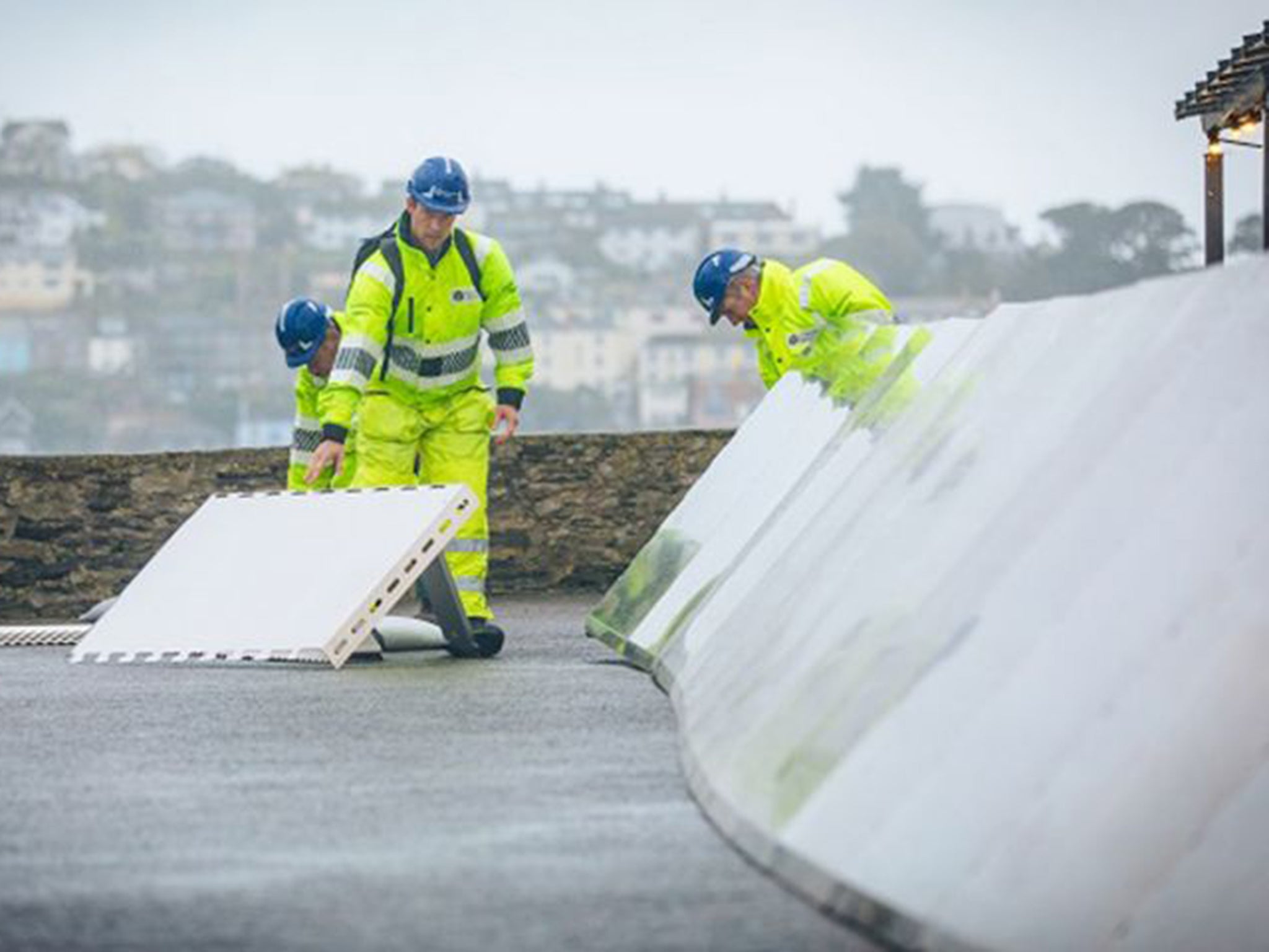 Temporary coastal barriers have been placed in Fowey, Cornwall, ahead of heavy wind and rain