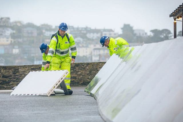 Temporary coastal barriers have been placed in Fowey, Cornwall, ahead of heavy wind and rain
