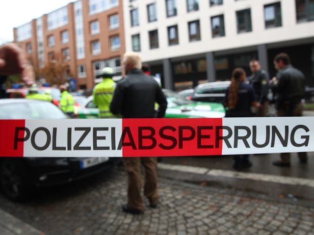 German police officers guard the site where earlier a man injured several people in a knife attack in Munich