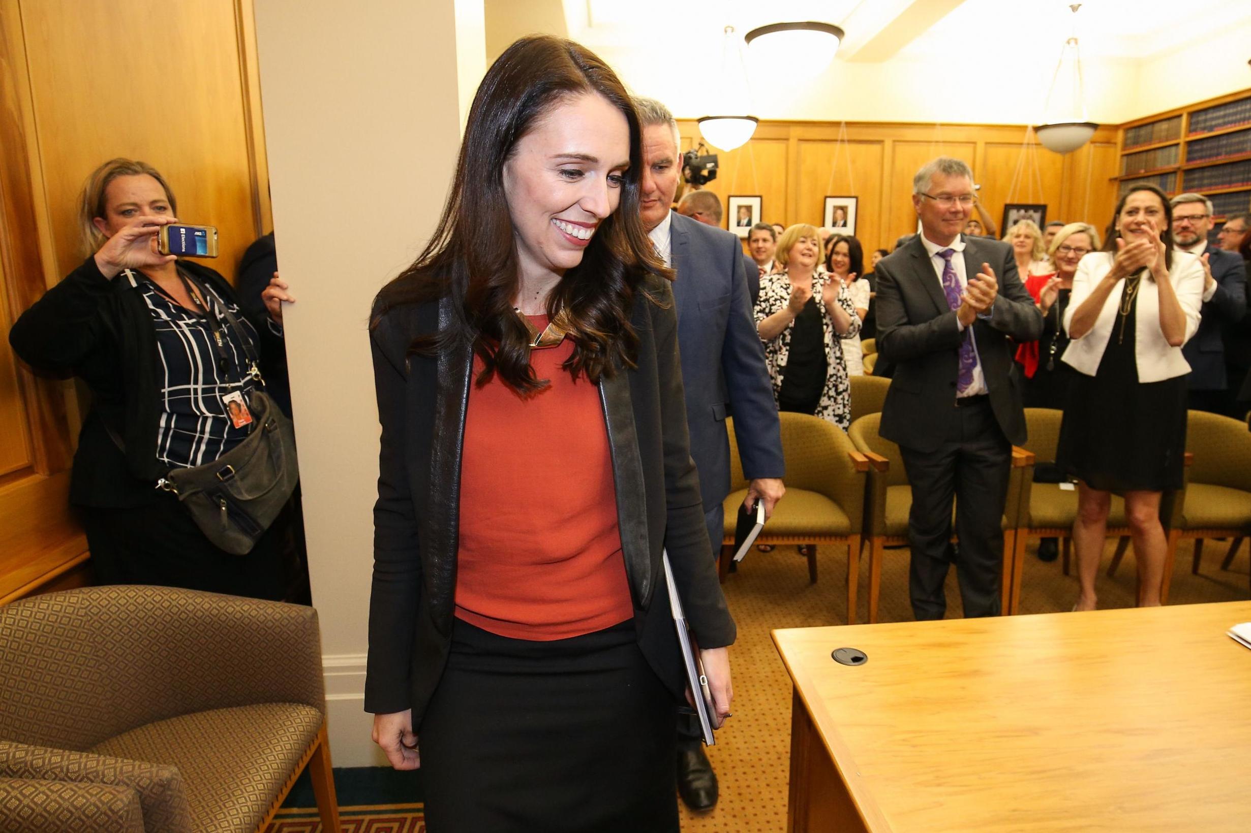 Lacinda Ardern receives a standing ovation as she arrives at Parliament after agreeing a deal to form a coalition government