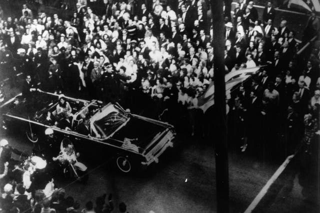 22nd November 1963: US statesman John F Kennedy, 35th president of the US, and his wife Jackie Kennedy travelling in the presidential motorcade at Dallas, before his assassination.