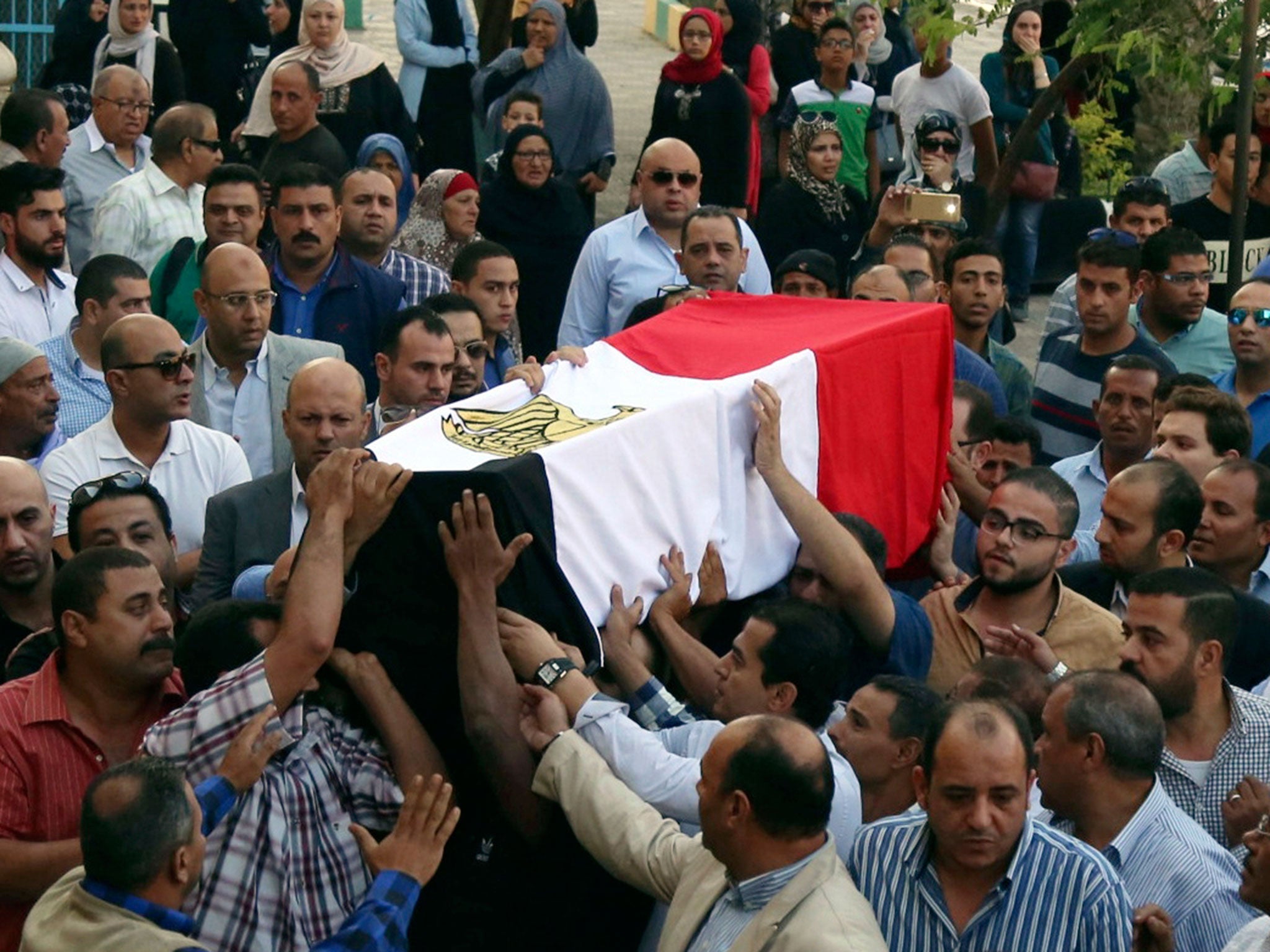 The coffin of police captain Ahmed Fayez, killed in the battle in al-Wahat al-Bahriya, is carried