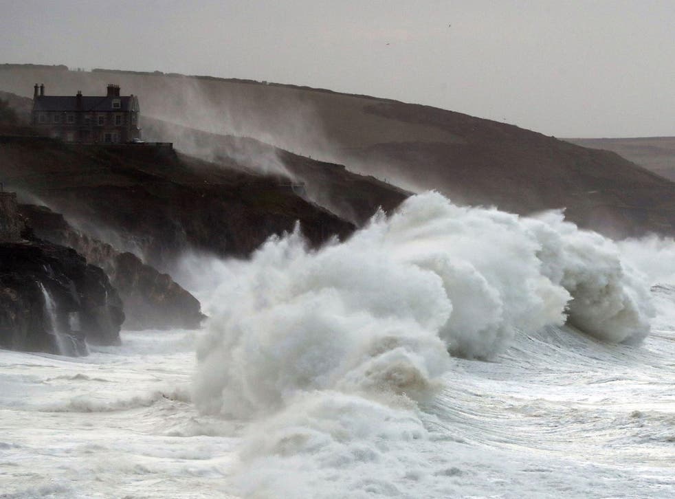 Waves crash into the seafront in Porthleven in Cornwall during Storm Brian