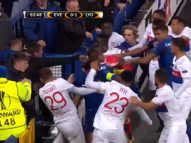 An Everton fan tries to hit Lyon goalkeeper Anthony Lopes