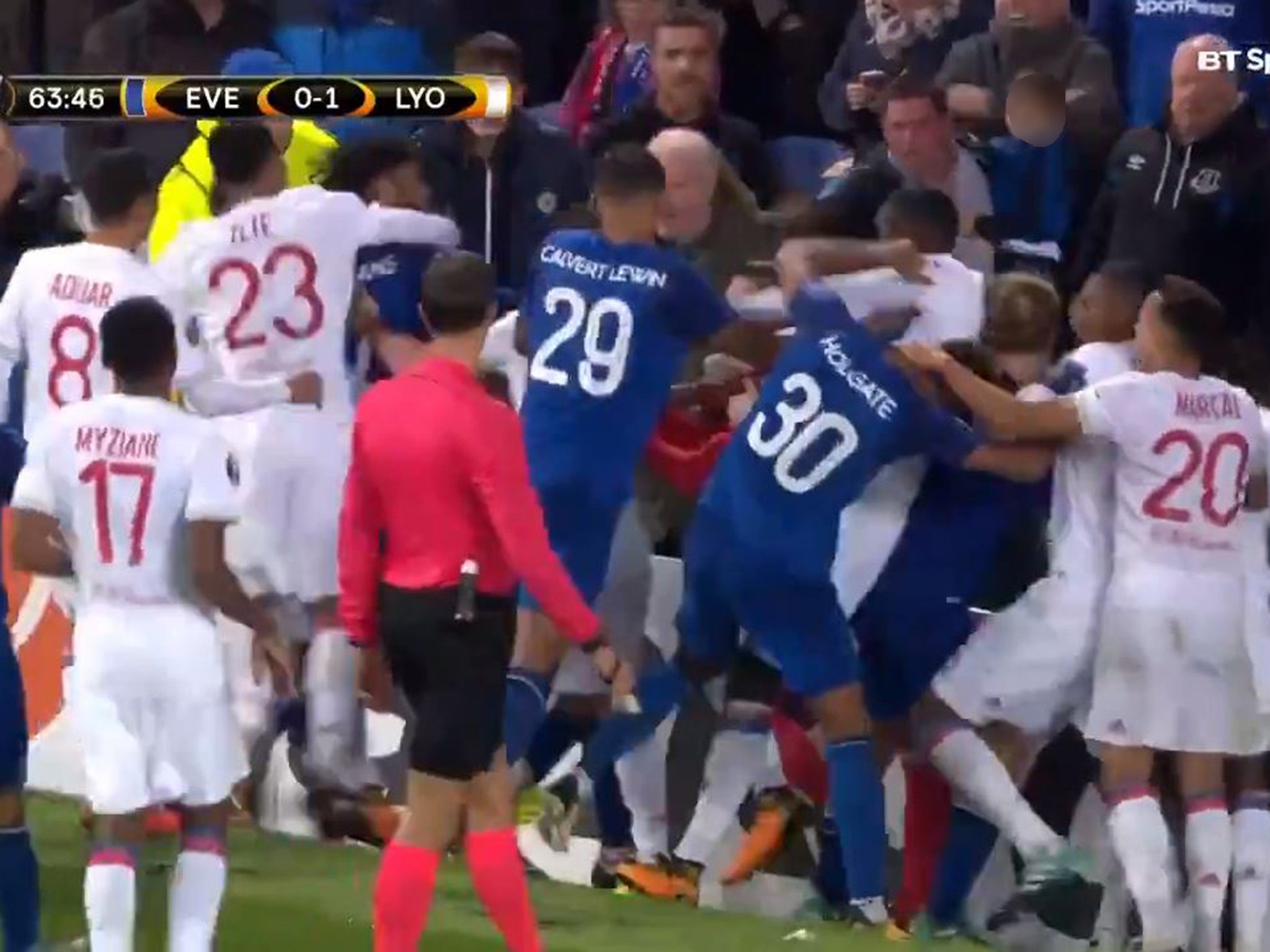 Everton and Lyon fans brawl while a fan tries to hit a player while holding his son