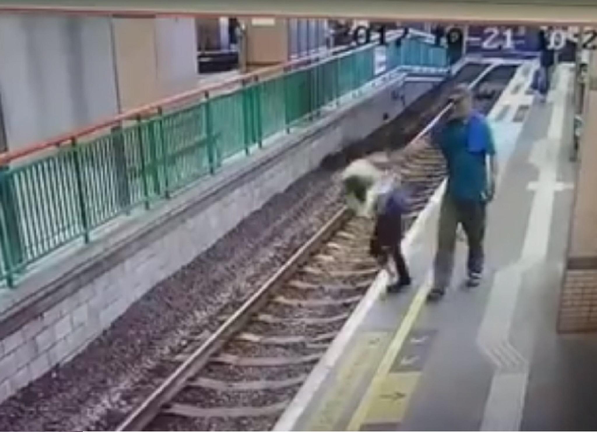 Shocking footage shows man calmly shoving woman onto railway tracks in Hong Kong