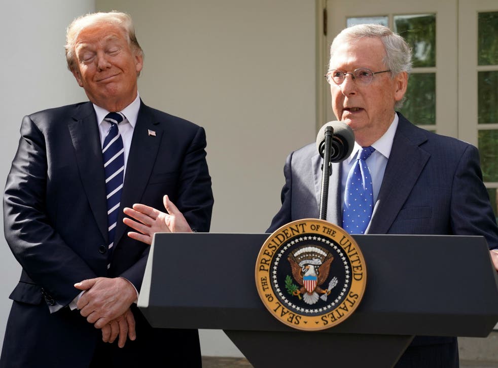 Mitch McConnell speaks to the media with U.S. President Donald Trump at his side in the Rose Garden of the White House in Washington on October 16, 2017