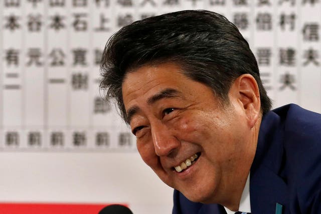 Japan's Prime Minister Shinzo Abe, leader of the Liberal Democratic Party (LDP), smiles during a news conference after winning his country's lower house election