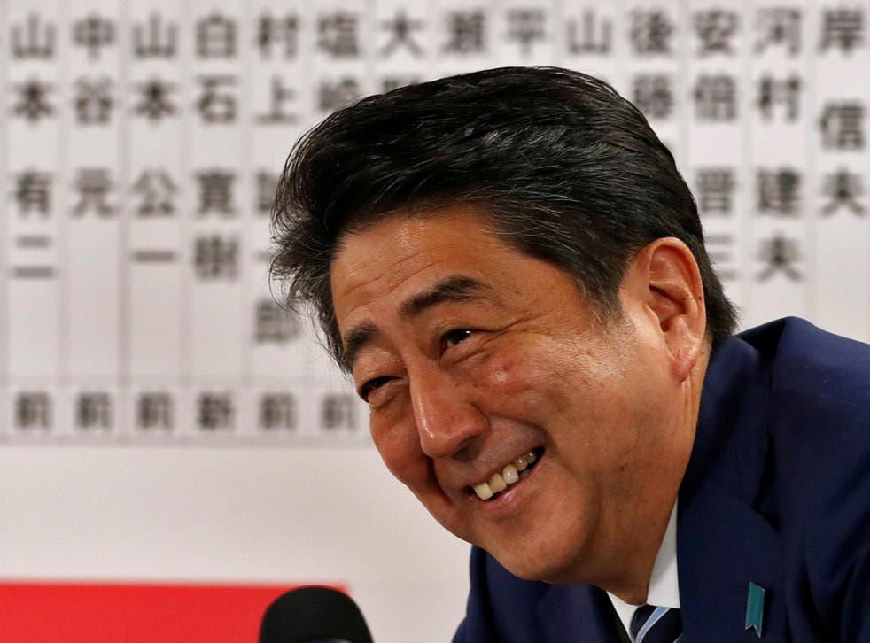 Japan's Prime Minister Shinzo Abe, leader of the Liberal Democratic Party (LDP), smiles during a news conference after winning his country's lower house election