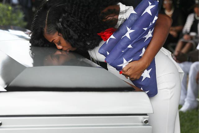 Myeshia Johnson kisses the casket of her husband US Army Sergeant La David Johnson during his burial service at the 21 October 2017 in Hollywood, Florida.