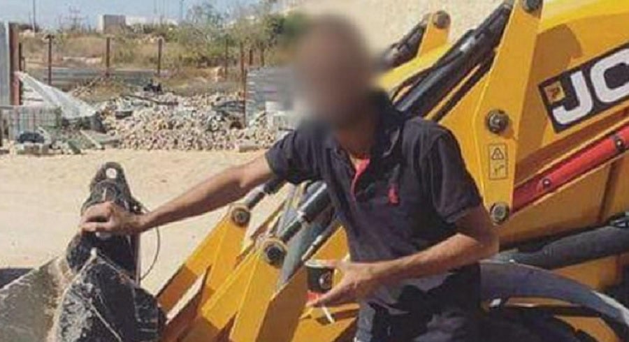 The man posted a photo of himself on a construction site in the West Bank