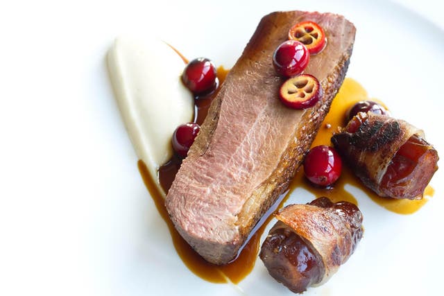 Bacon-wrapped dates flank the goose on a bed of celeriac purée 