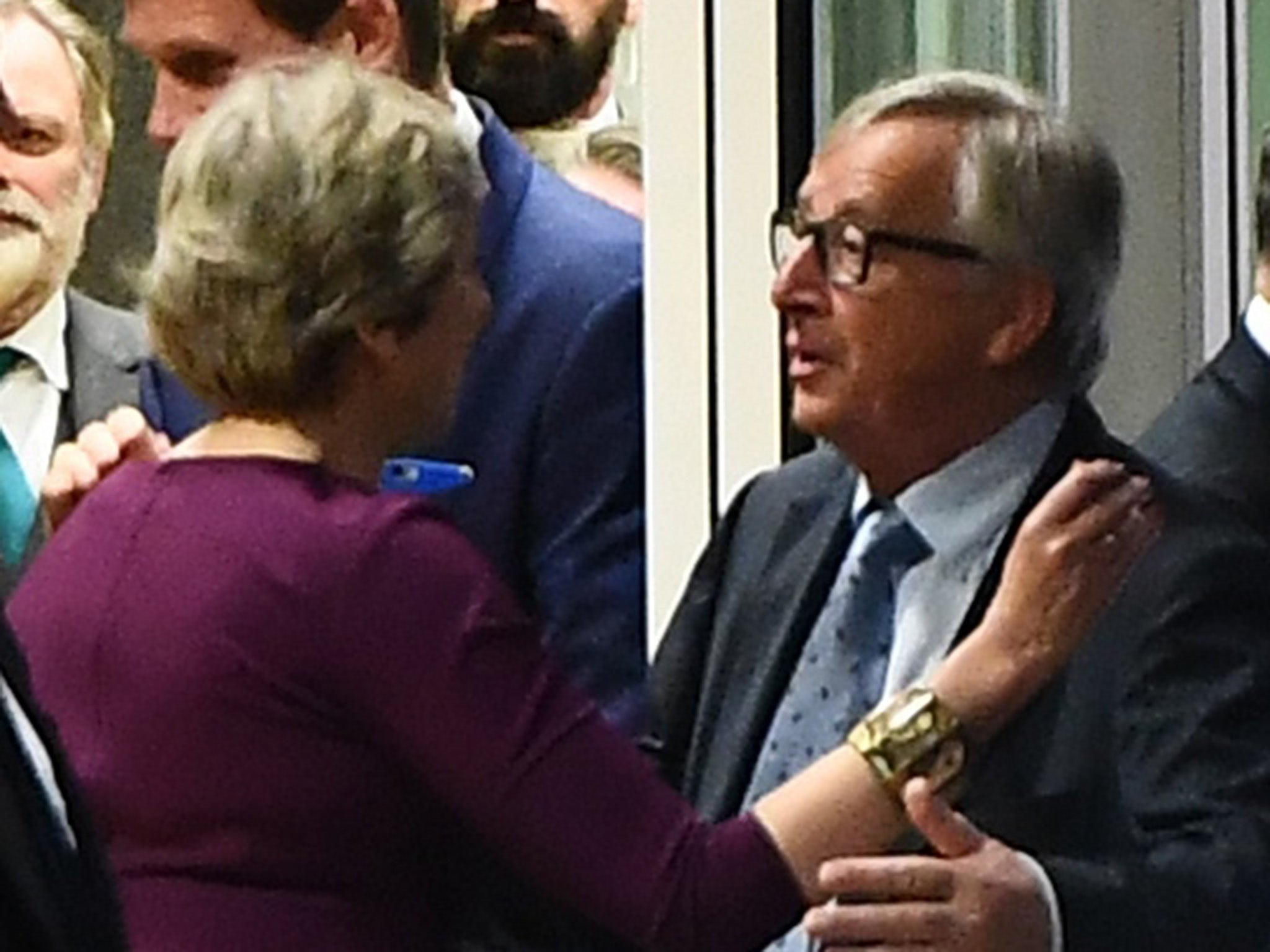 Theresa May hugs Jean-Claude Juncker after a meeting at the European Commission