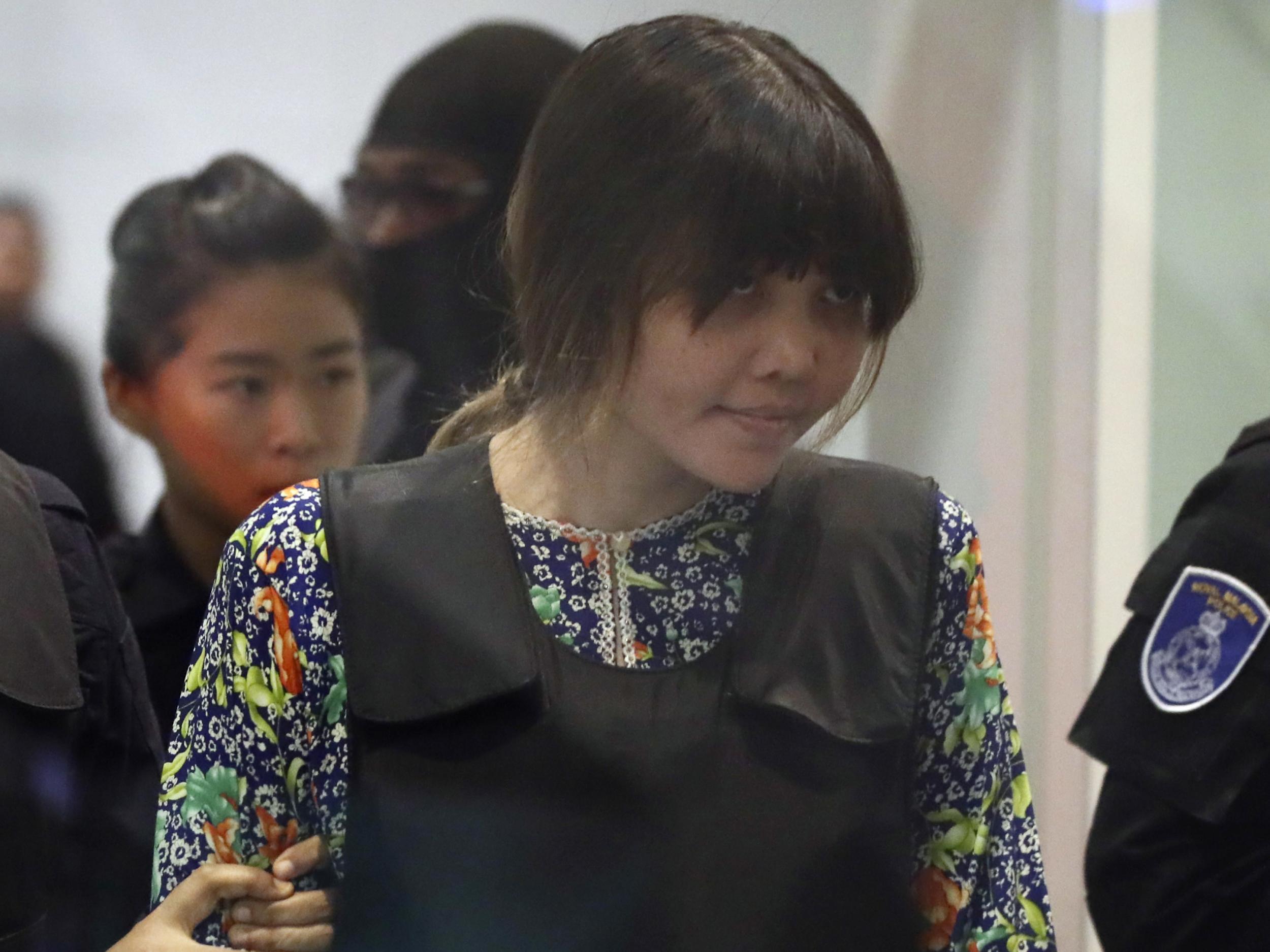 Vietnamese national Doan Thi Huong is escorted by police as she arrives at Kuala Lumpur International Airport in Sepang