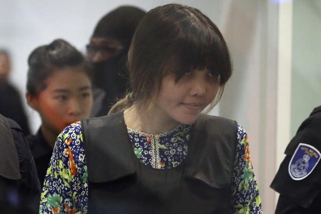 Vietnamese national Doan Thi Huong is escorted by police as she arrives at Kuala Lumpur International Airport in Sepang