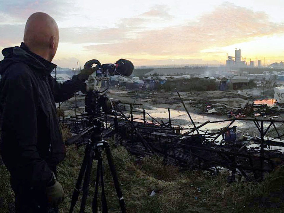 &#13;
Director Dan Reed films the ruins of the burnt-out Calais Jungle, the day after its eviction by French authorities &#13;