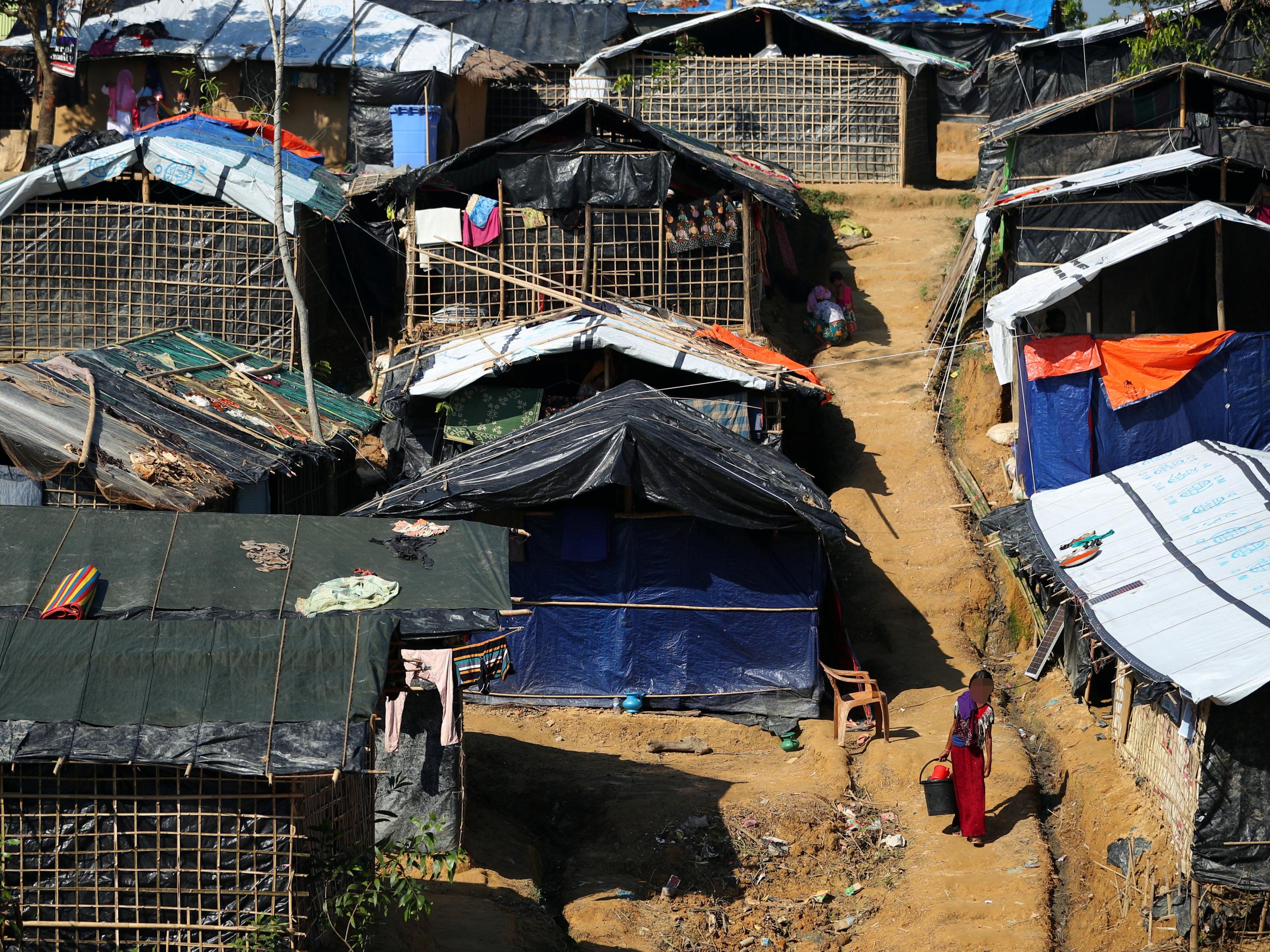 In Kutupalong Camp, Bangladesh, two whole families live together under a single piece of tarpaulin