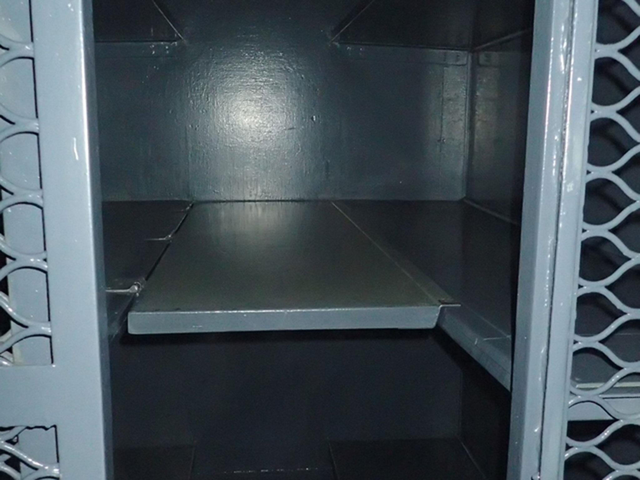 A compartment on a prison train carriage showing the small seventh bunk, between the two middle bunks