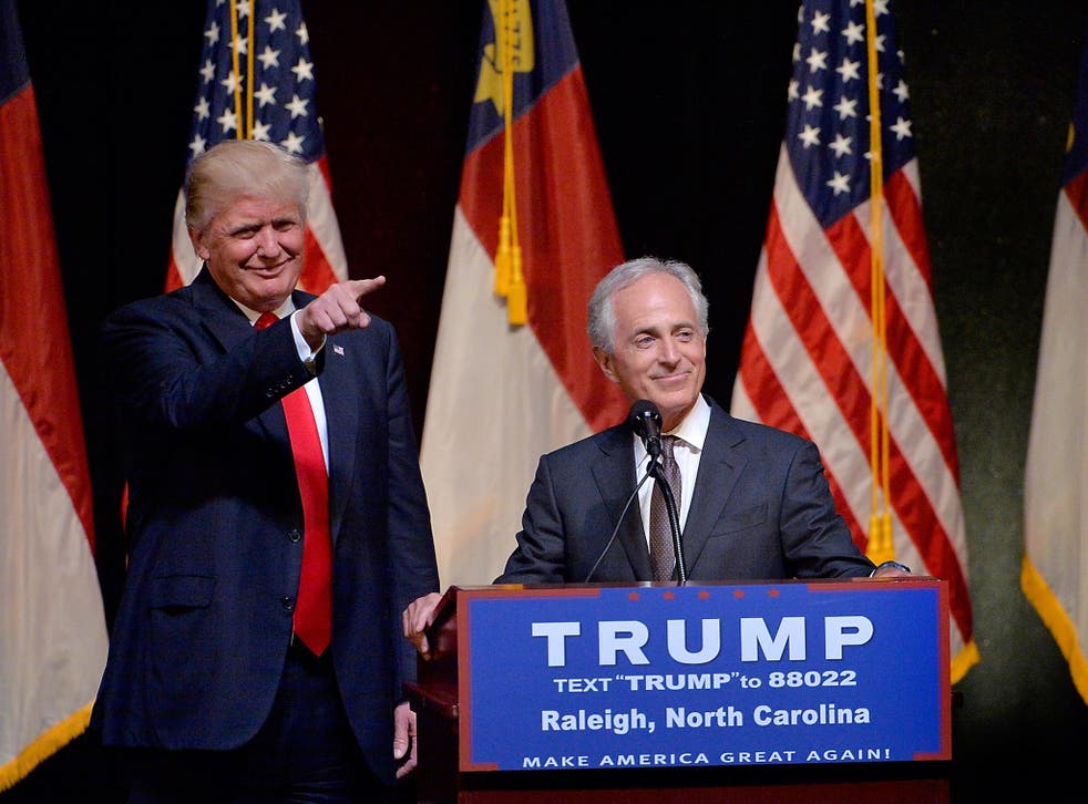Presumptive Republican presidential nominee Donald Trump stands next to Senator Bob Corker during a campaign event in 2016. The President and Mr Corker are now fighting.