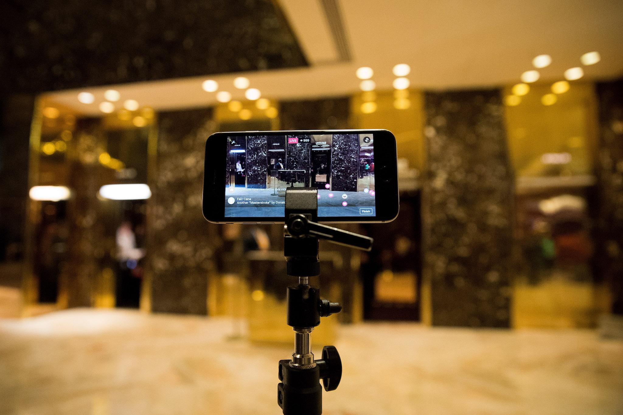 An iPhone streams a 'Facebook Live' live feed of the lobby at Trump Tower, November 29, 2016 in New York City