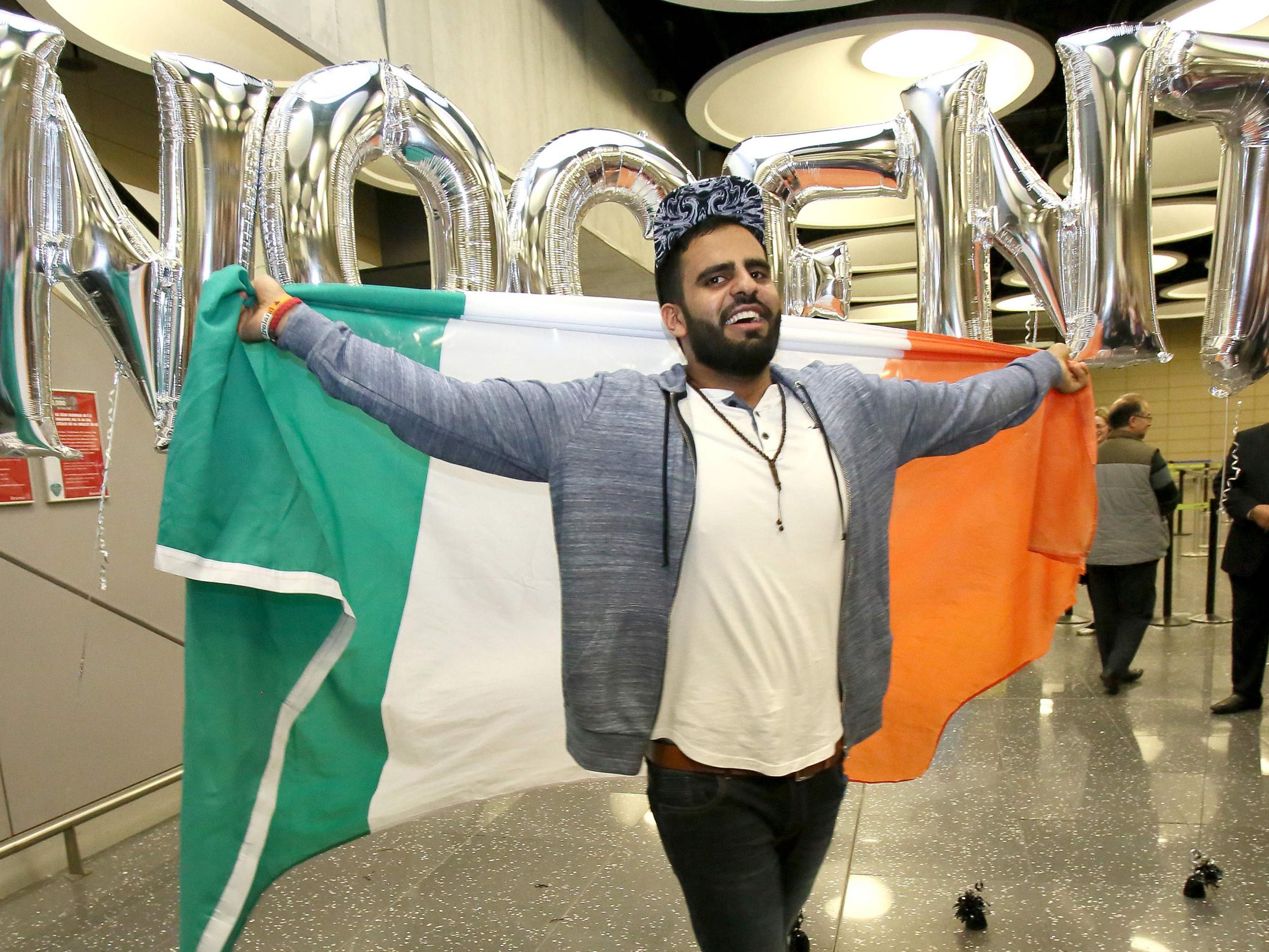 Irish citizen Ibrahim Halawa poses with an Irish flag as he arrives at Dublin Airport following his release from detention in Egypt