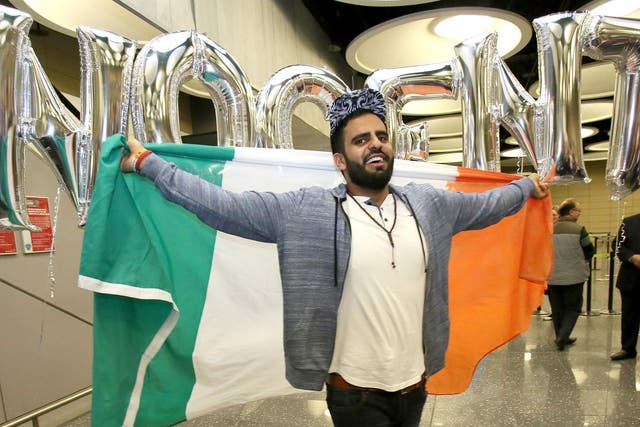 Irish citizen Ibrahim Halawa poses with an Irish flag as he arrives at Dublin Airport following his release from detention in Egypt