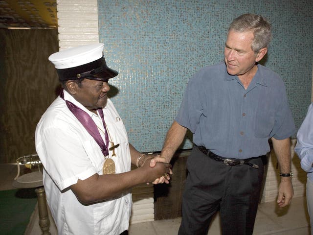 Fats Domino shaking the hand of George W. Bush after being given a new National Medal of Arts