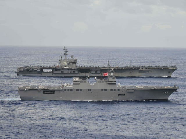 The USS Ronald Reagan sails alongside Japan's Hyuga-class helicopter destroyer Ise