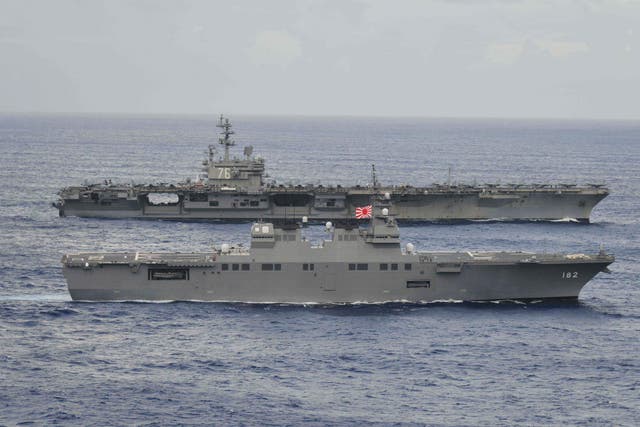The USS Ronald Reagan sails alongside Japan's Hyuga-class helicopter destroyer Ise