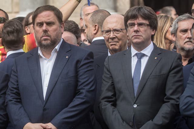 Catalan Vice-President Oriol Junqueras (right) standing with President Carles Puigdemont in Barcelona the day after the referendum