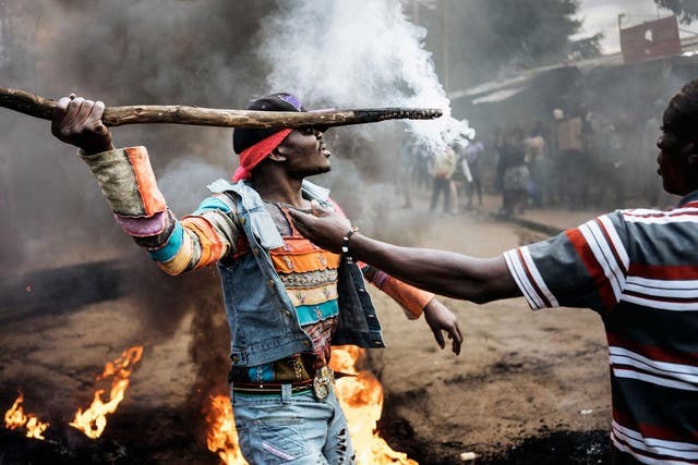 Opposition supporters demonstrate at a burning barricade during a protest in Kibera, Nairobi