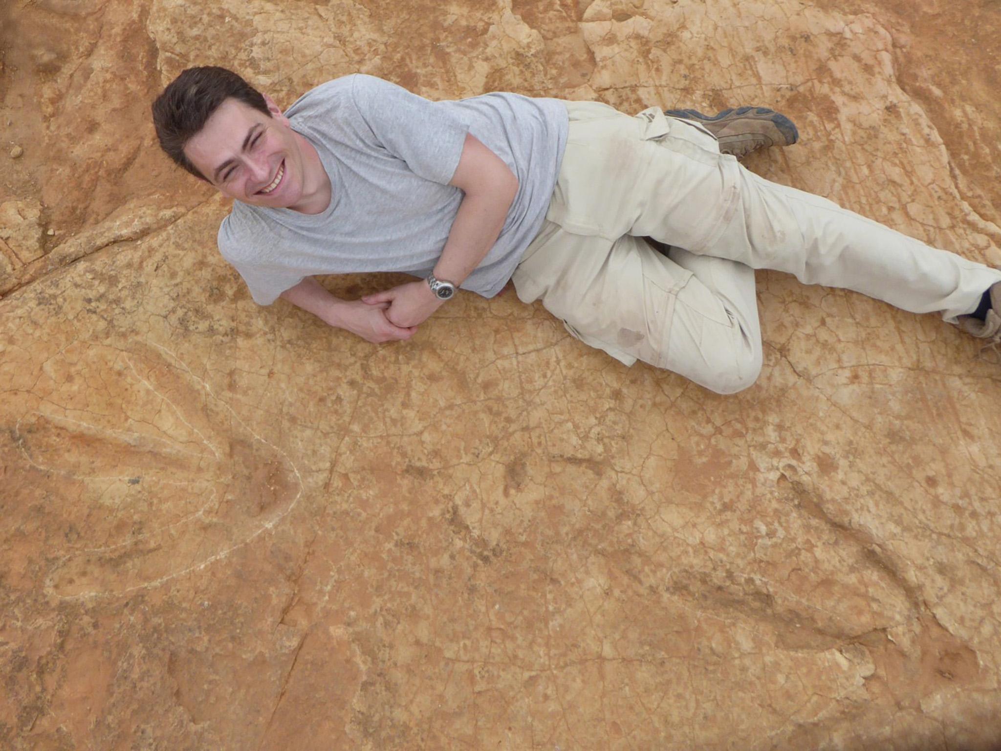 Dr Fabien Knoll from the University of Manchester poses with the footprints in South Africa