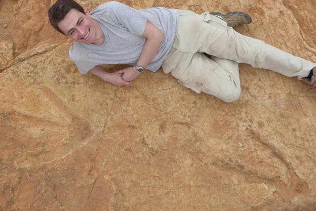 Dr Fabien Knoll from the University of Manchester poses with the footprints in South Africa