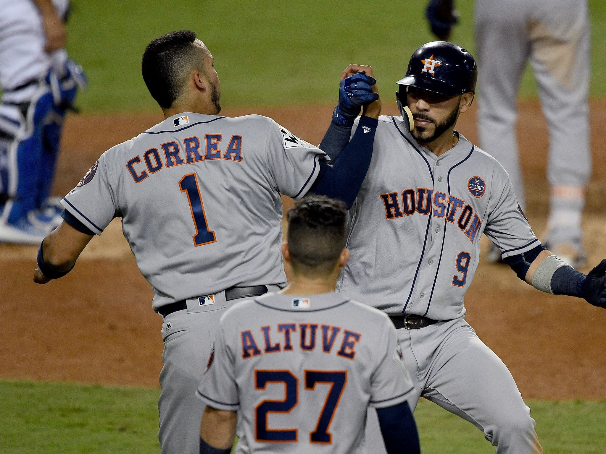 Marwin Gonzalez of the Houston Astros celebrates with Carlos Correa after hitting a solo home run during the ninth inning