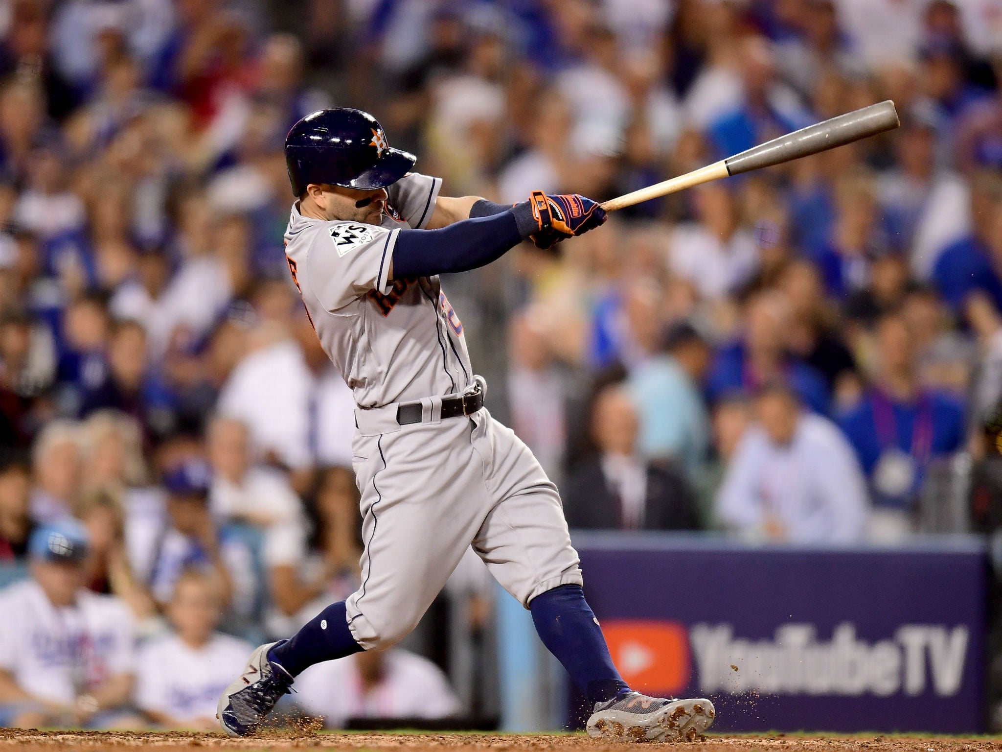 Jose Altuve of the Houston Astros hits a solo home run during the tenth inning