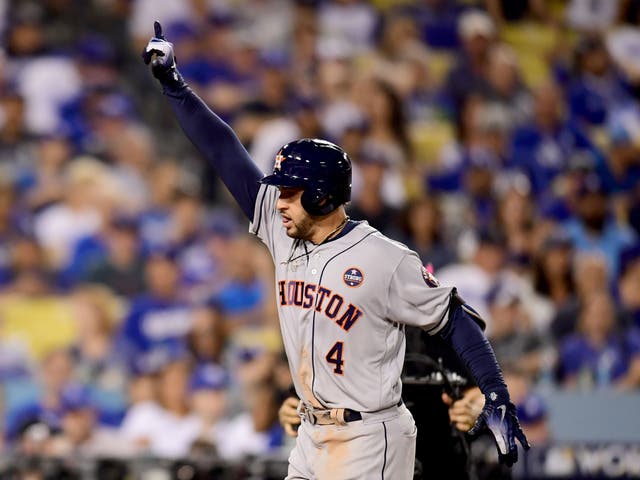 George Springer celebrates after hitting a two-run home run for the Astros during the eleventh inning