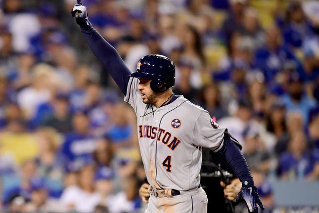 George Springer celebrates after hitting a two-run home run for the Astros during the eleventh inning