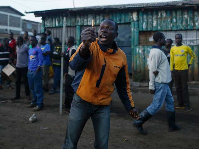 A supporter of the opposition coalition holds up a bullet casing allegedly fired by police as he and others face off with police during their protest in Kibera slum, an opposition stronghold in Nairobi