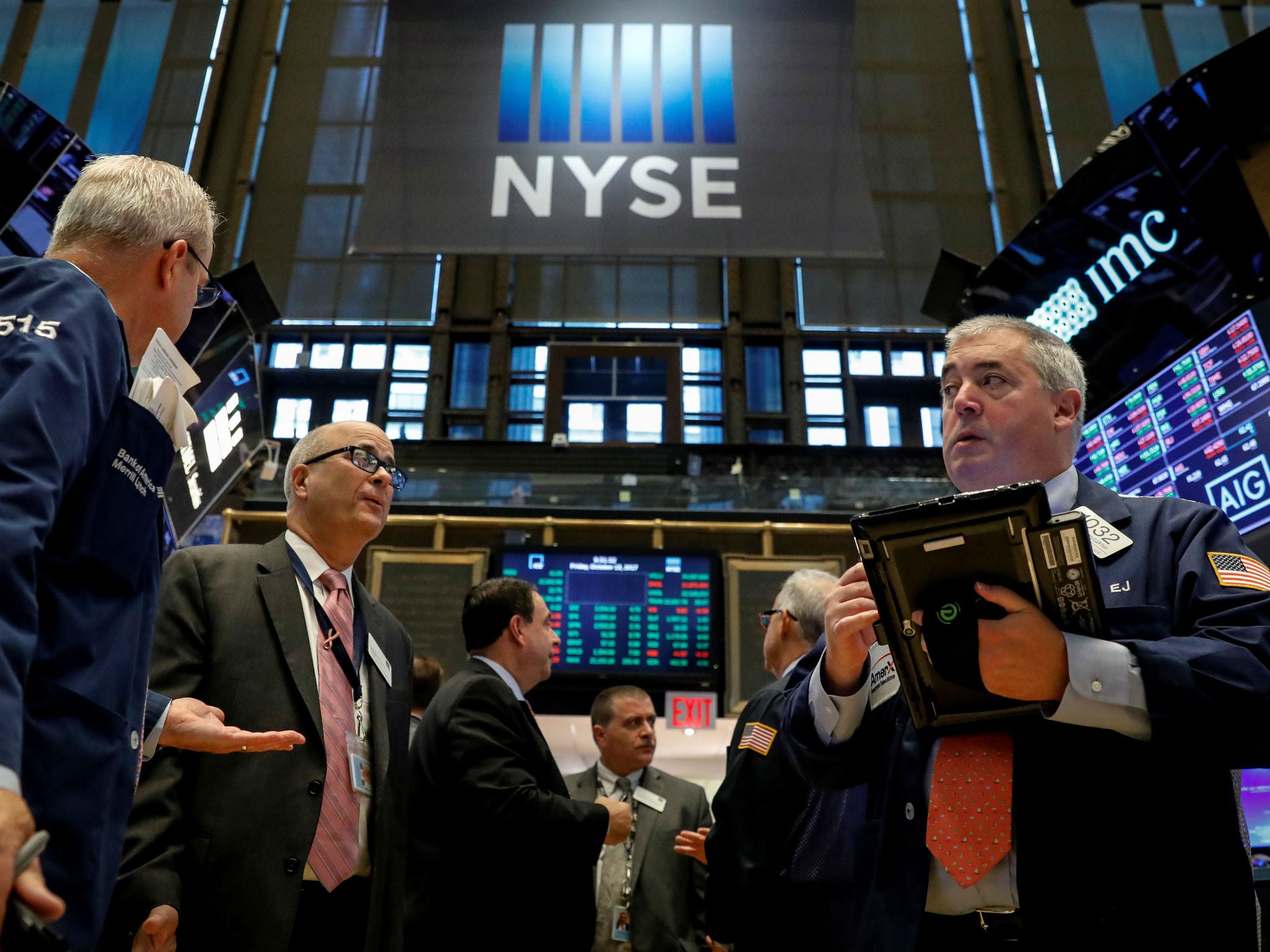 Traders work on the floor of the New York Stock Exchange in New York on October 13, 2017.