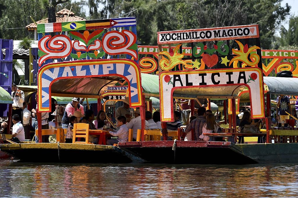 Trajinera boats ply the waters in the Xochimilco canals (AFP/Getty)