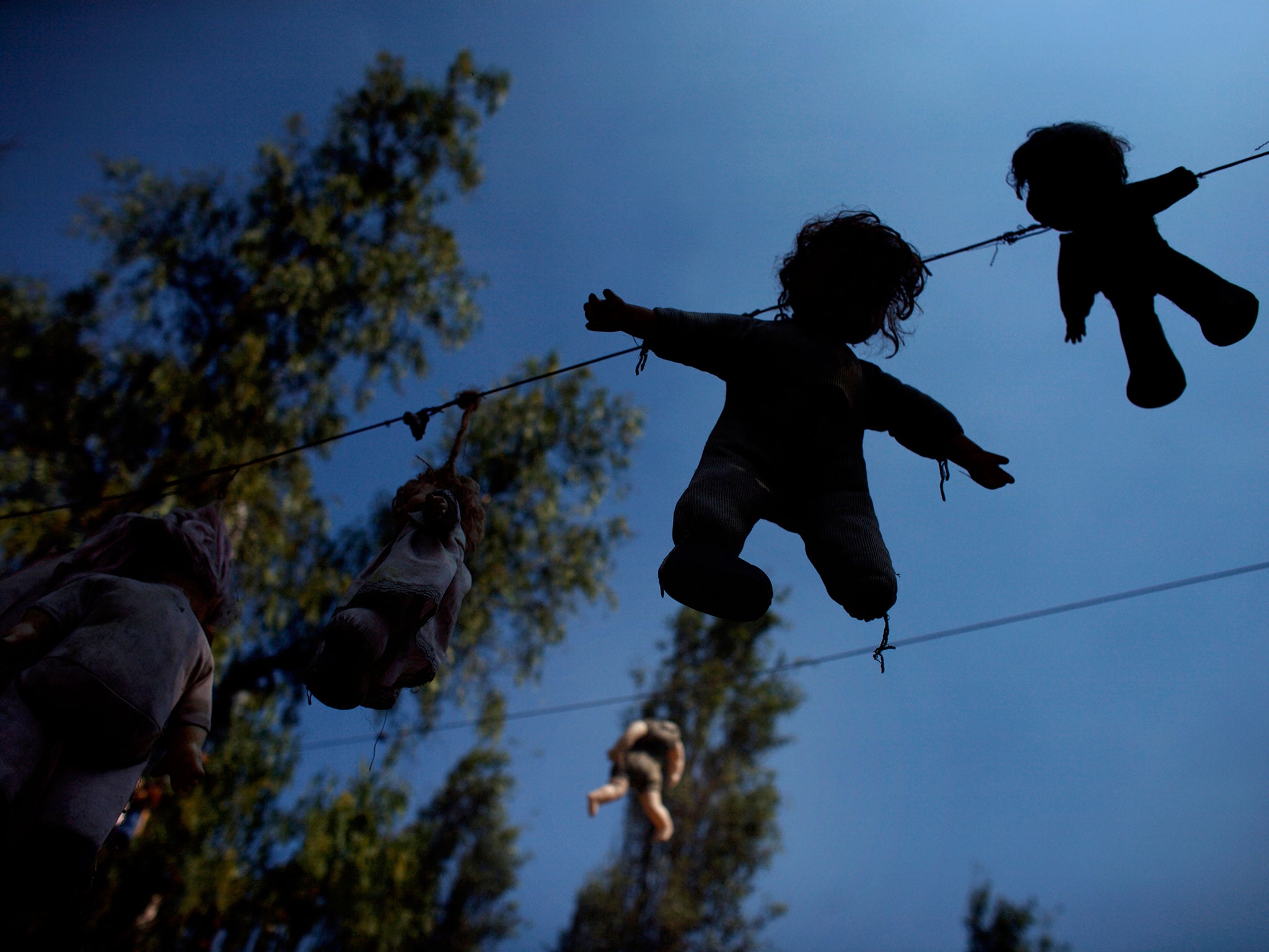 Dolls hang on a clothes line on the Island of the Dolls in Xochimilco